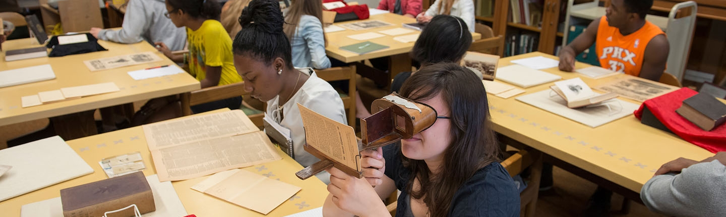 Occidental College students working in Special Collections looking at old photos