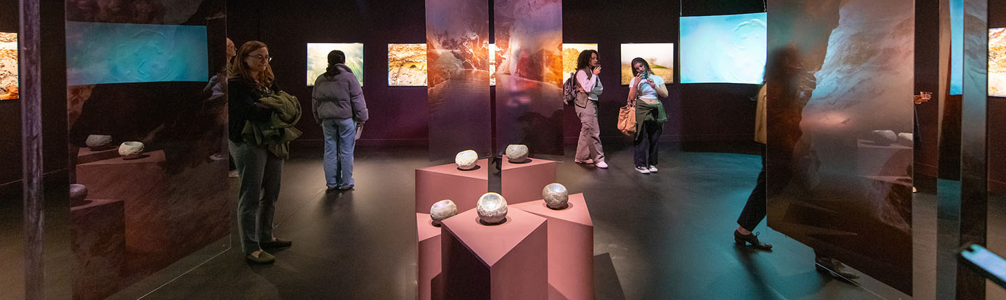 Inside an Oxy Arts exhibition gallery, with sculptures and hanging installments on either side.