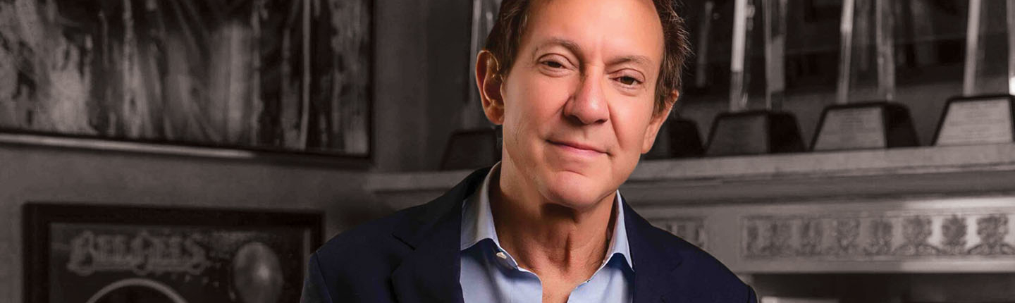 John Branca in a collared shirt and blazer in his office