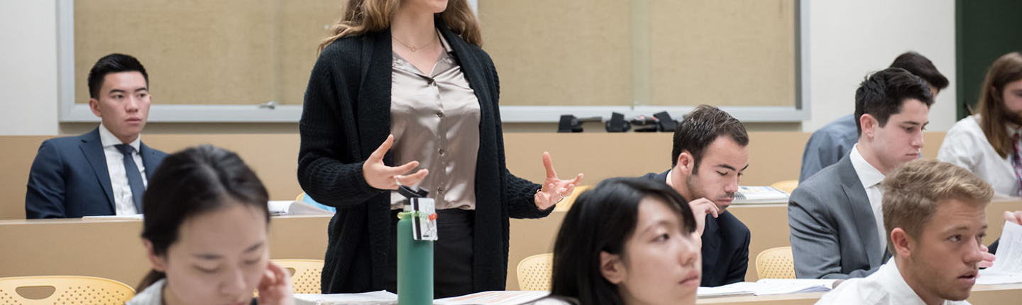 an Occidental College classroom of students and a young woman standing up to talk