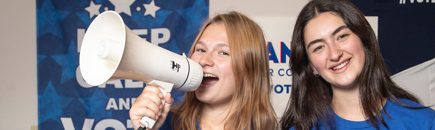 Two Oxy students together, one holding a megaphone
