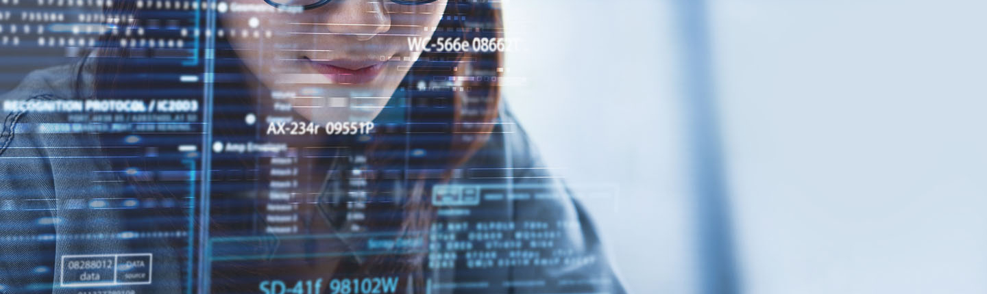 a young woman smiling as she looks at a large computer screen full of data illustration