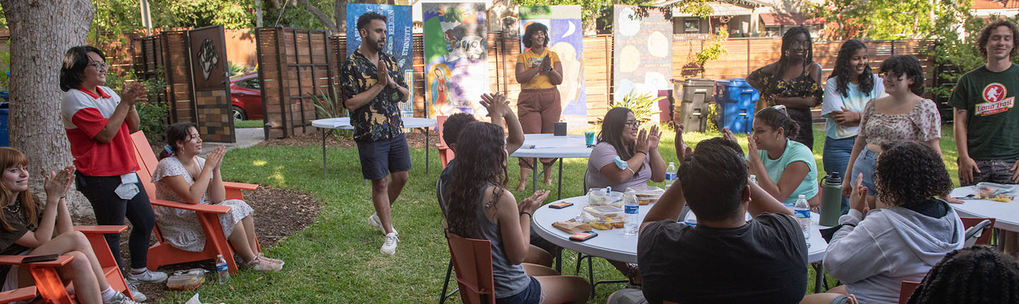 Occidental College students and staff gathered together for a group meal in the backyard of the ICC