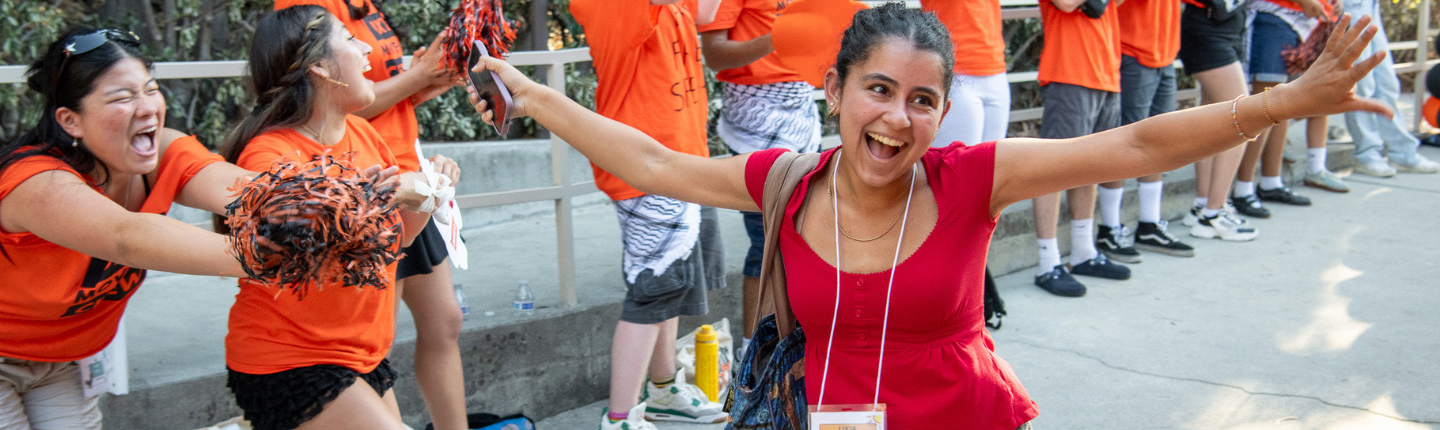 O-Team member cheer on new students as they walk into Remsen Bird Hillside Theater