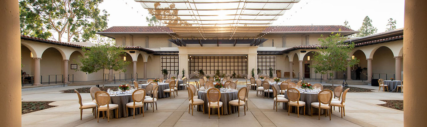 A view of Cannon Plaza set up with tables and chairs and place settings.