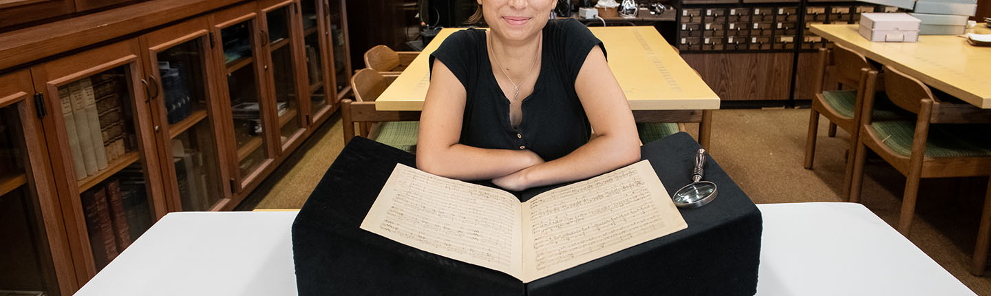 Francesca Rodoni '24 examining a musical manuscript of Franz Liszt