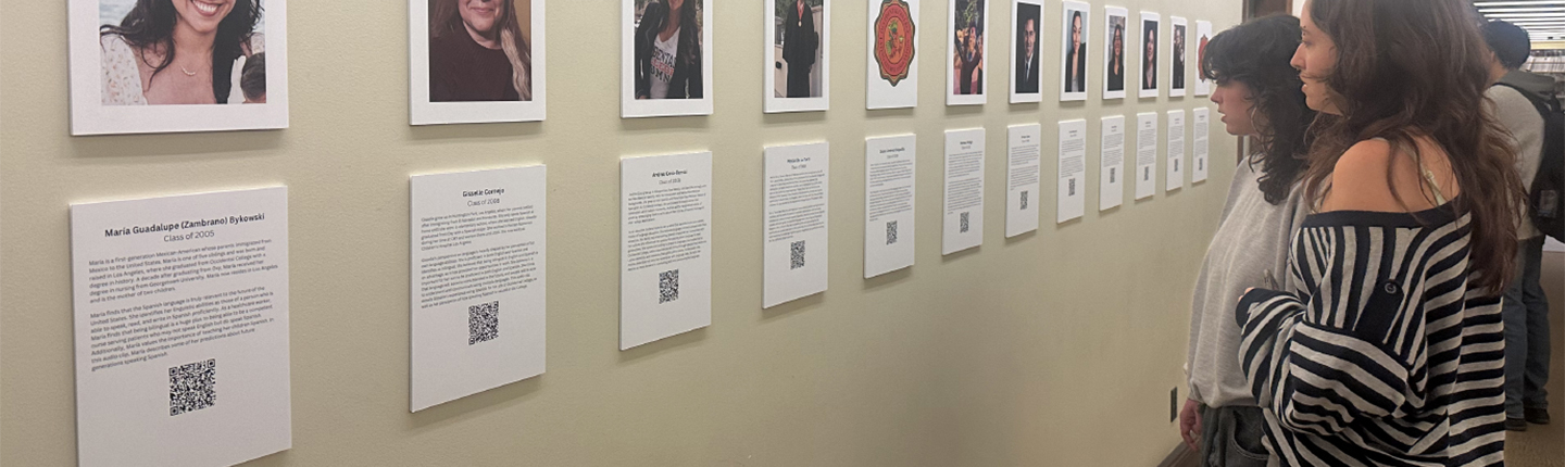 Spectators view the OCLAA oral history gallery in the Academic Commons in February 2024.