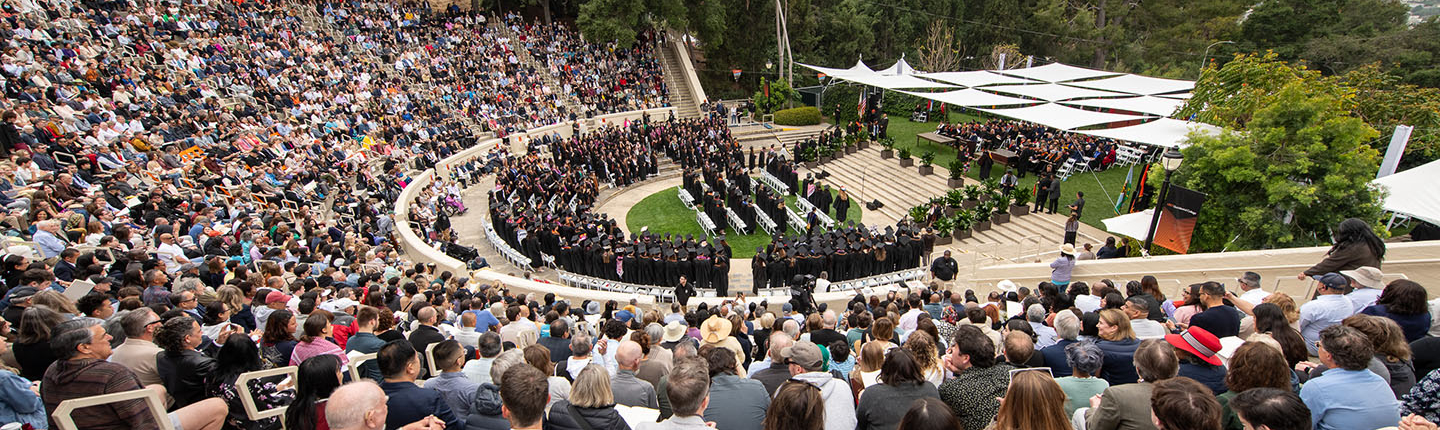 A panorama view of Remsen Bird Hillside Theater at Occidental College full of people on Commencement Day 2024