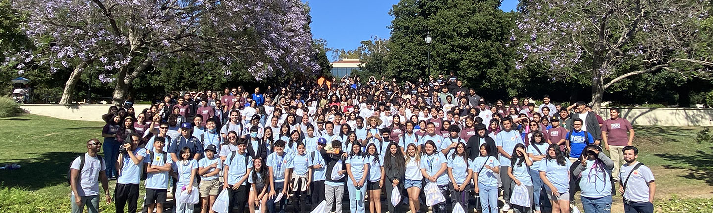 A large group of Upward Bound students pose on the steps by Gilman Fountain on campus
