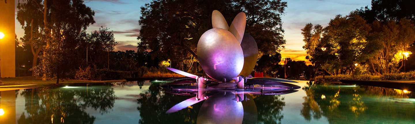 The renovated Gilman Fountain illuminated by a rainbow of colors at dusk