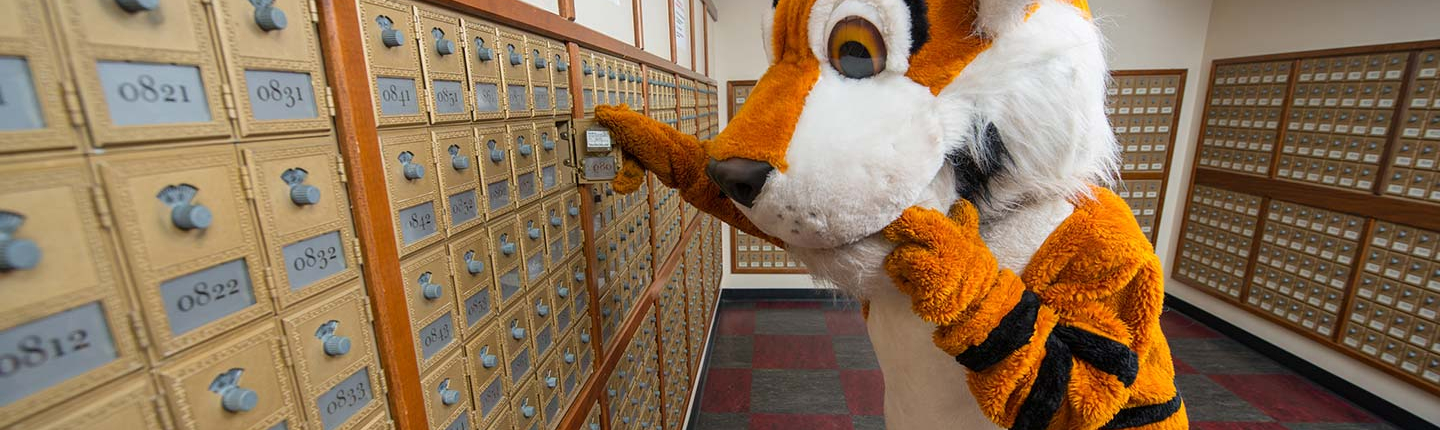 Oswald the Tiger checks his mail in Oxy's mailroom