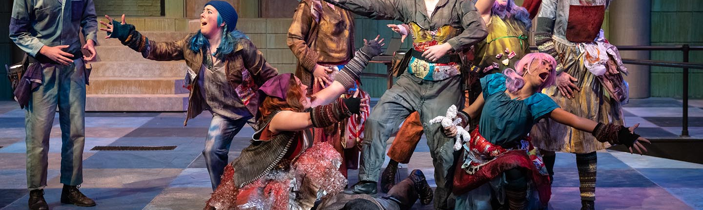 actors on a stage, all in dramatic poses