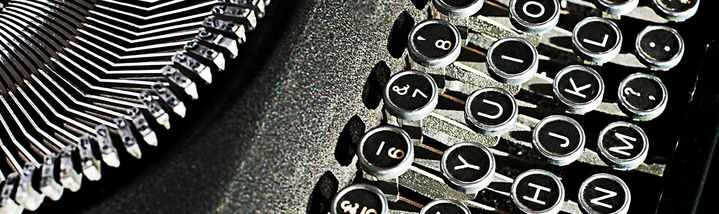 a close-up shot of a black and white typewriter