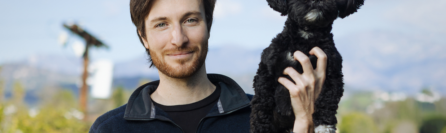 Zak Stoltz '10 with his dog, Boba, at his home in Mount Washington.