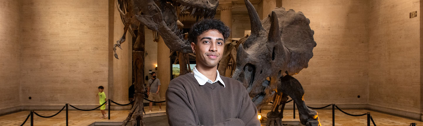 Oxy student standing in front of an exhibit at the Natural History Museum