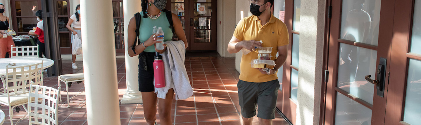 Two students with masks on campus