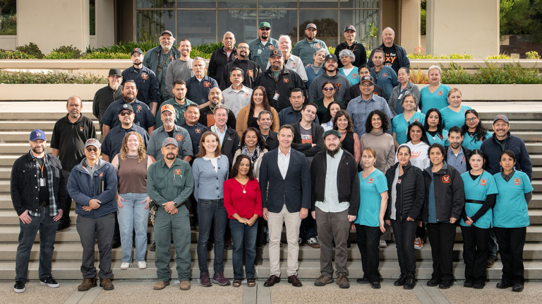 A large group of Facilities Management staff on the steps at Occidental College