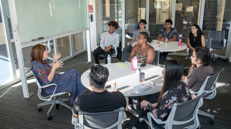 A cohort of Barack Obama Scholars at Occidental College having a lively discussion in a classroom with Sara El-Amine '07