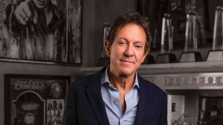 John Branca in a collared shirt and blazer in his office