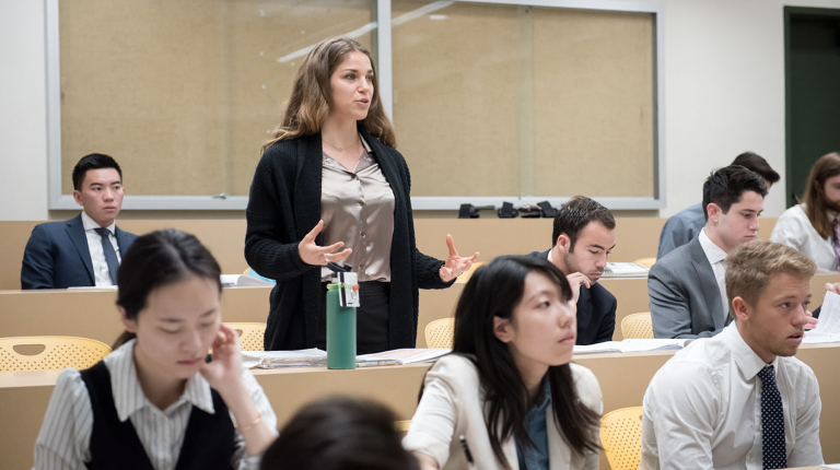 an Occidental College classroom of students and a young woman standing up to talk