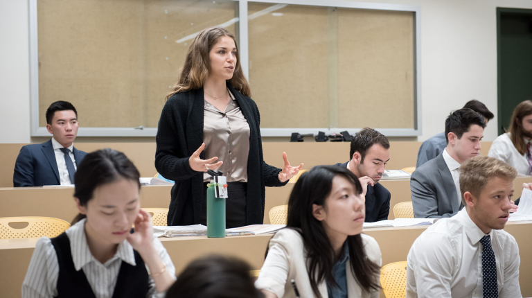 an Occidental College classroom of students and a young woman standing up to talk
