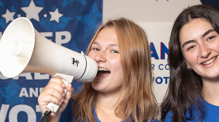 Two Oxy students together, one holding a megaphone