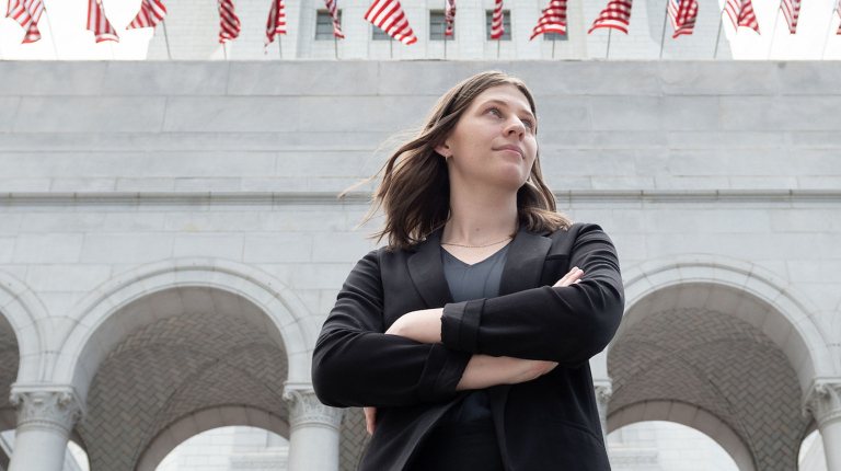 An Occidental College student intern standing in front of City Hall in downtown Los Angeles