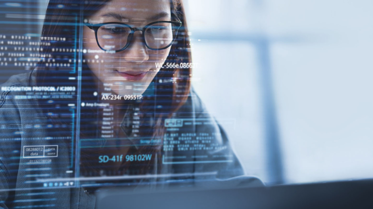 a young woman smiling as she looks at a large computer screen full of data illustration