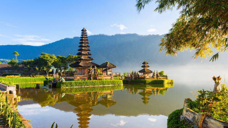 A historical building next to a river in Indonesia