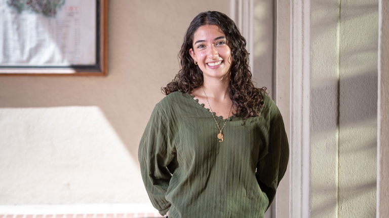Aoife Mokalla ’28 standing against a wall with a green top
