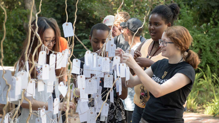 Oxy students decorating the wishing tree at Orientation
