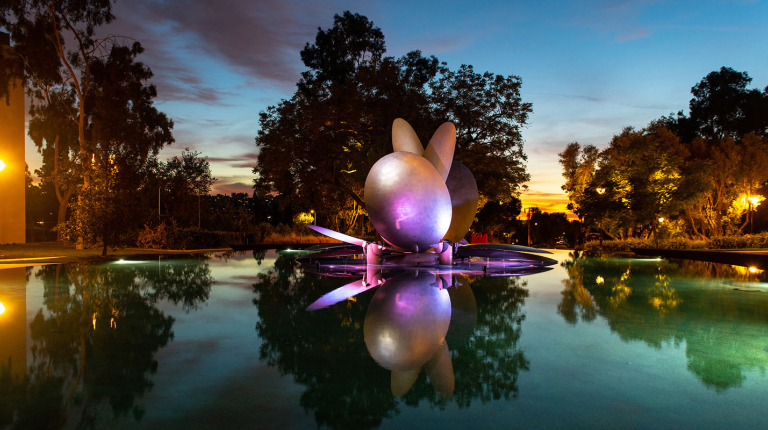 The renovated Gilman Fountain illuminated by a rainbow of colors at dusk