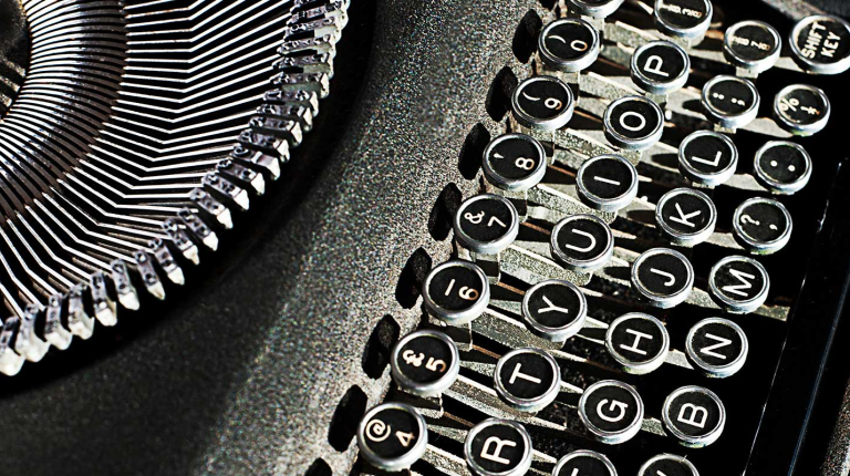 a close-up shot of a black and white typewriter