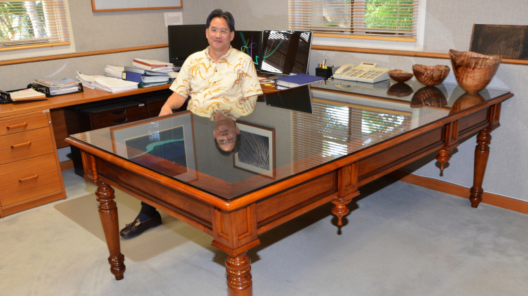 David Louie '73 behind the desk of the attorney general in Hawai'i.