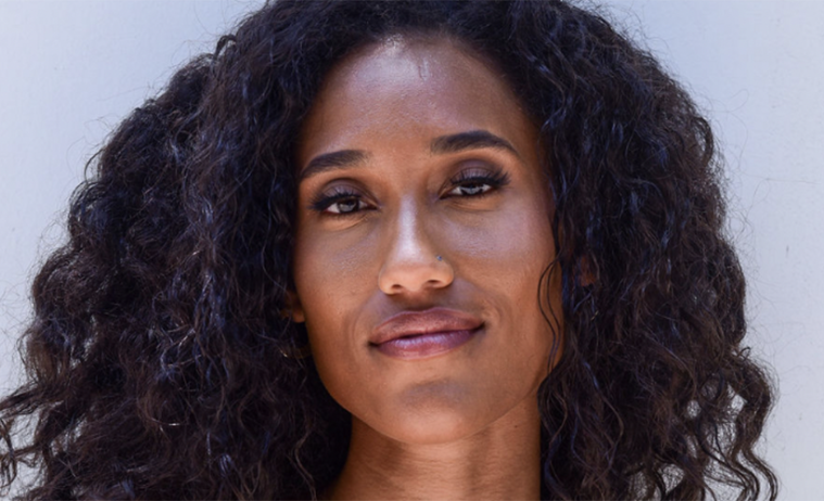 Headshot of Anna Tubbs with long curly dark hair