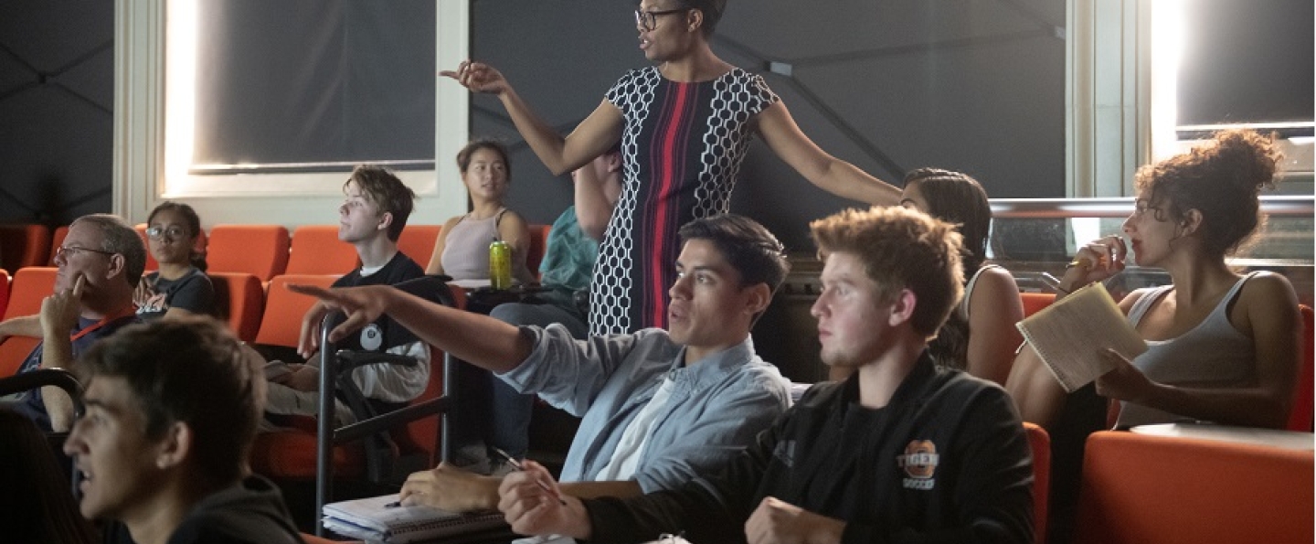Students in a classroom with a professor lecturing