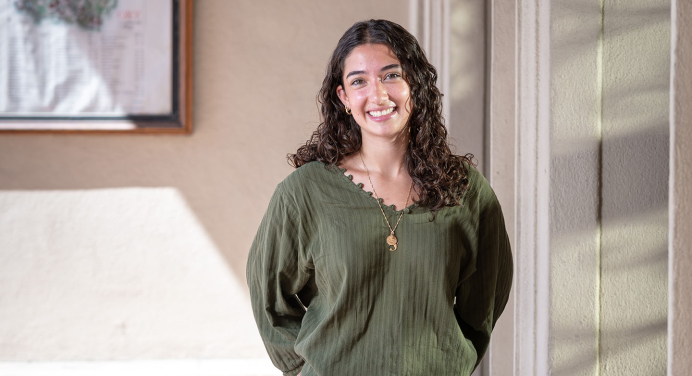 Aoife Mokalla ’28 standing against a wall with a green top