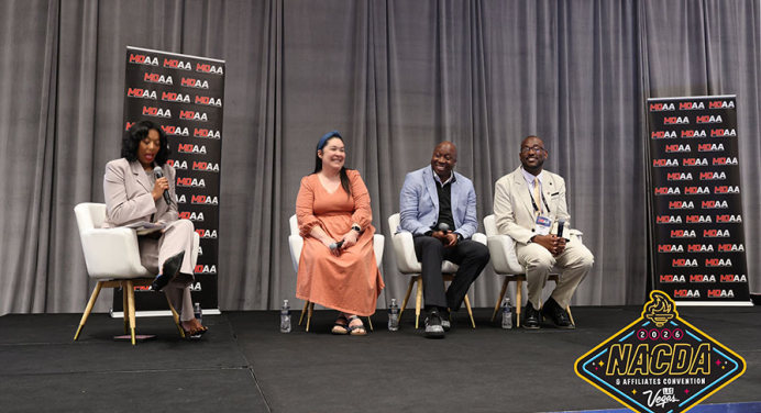 Awardees at the ceremony, four people seated on a stage