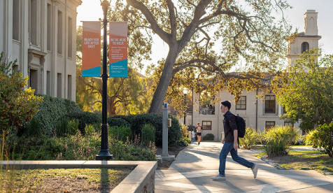 An Occidental students walks across the quad
