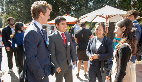 Four Occidental students in business attire at the Oxy Career Fair