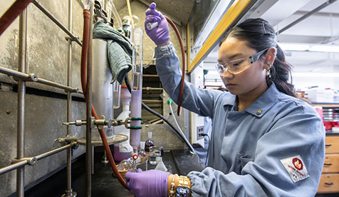Oxy student working with laboratory equipment