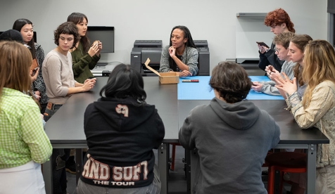 An Occidental College classroom full of students and a professor around a square table
