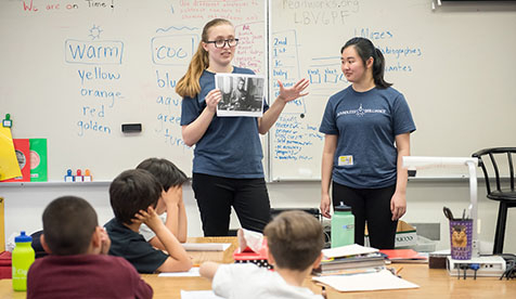Two Oxy students leading a class of children