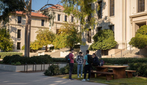 students standing in front of Fowler Hall, talking