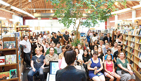 a large audience gathered a book reading, with a speaker at the front, at Skylight Books, a well-known independent bookstore located in Los Feliz, Los Angeles