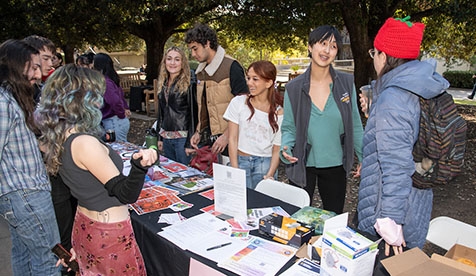 Oxy students gathered around a table at the Involvement Fair on campus