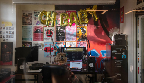 a student in the dj booth at the KOXY radio station