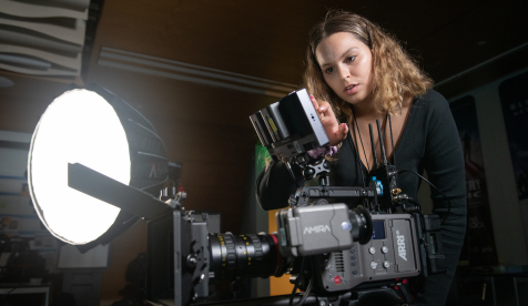 Occidental student using a professional video camera