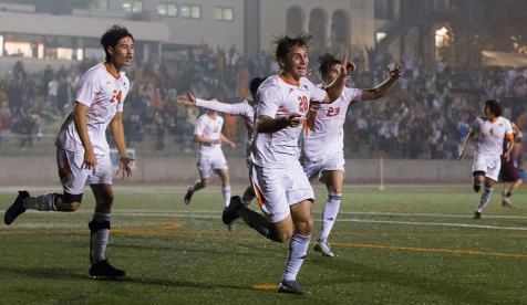 Occidental College men's soccer players in white jerseys out on the playing field