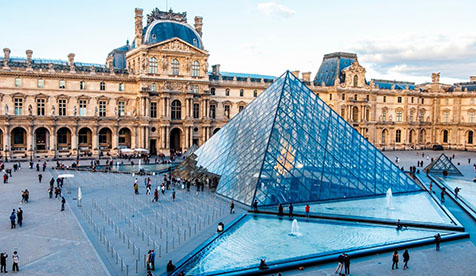 The Louvre modern art museum in Paris with its signature triangular glass dome